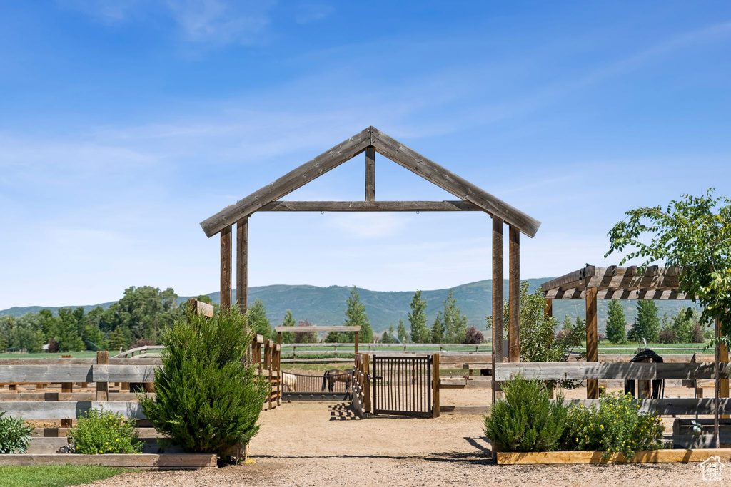Surrounding community featuring a mountain view and a pergola