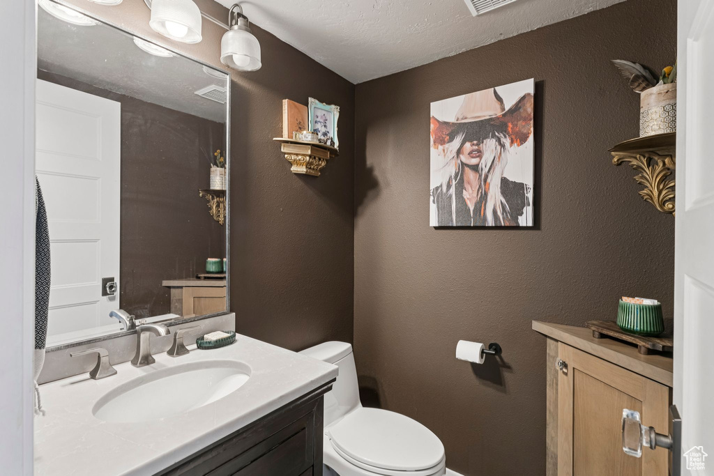 Bathroom featuring toilet and vanity