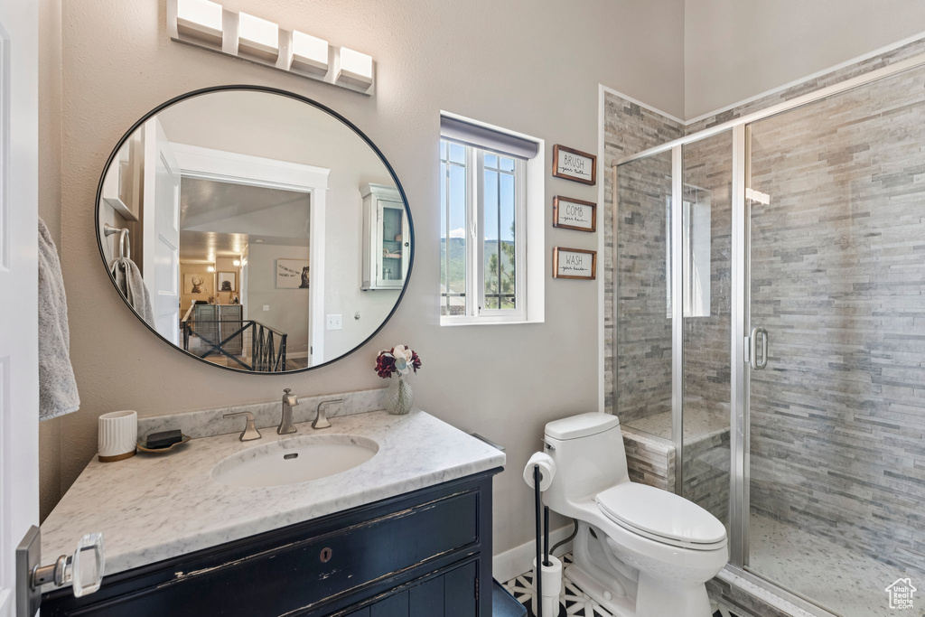 Full bathroom featuring vanity and a shower stall