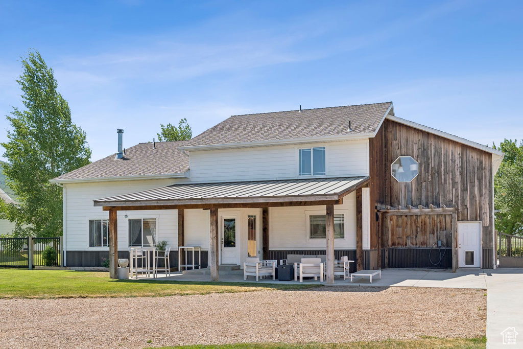 Back of house featuring an outdoor hangout area and a patio