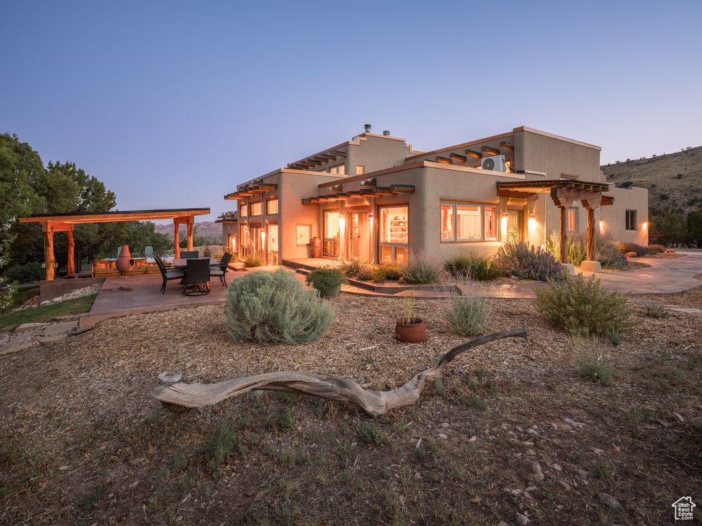 Rear view of house with a pergola and a patio