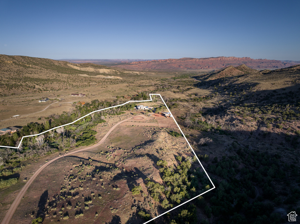 Aerial view of property and surrounding area with property parcel outlined and rural landscape