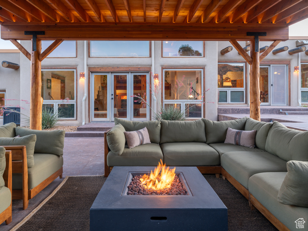View of patio with an outdoor living space with a fire pit