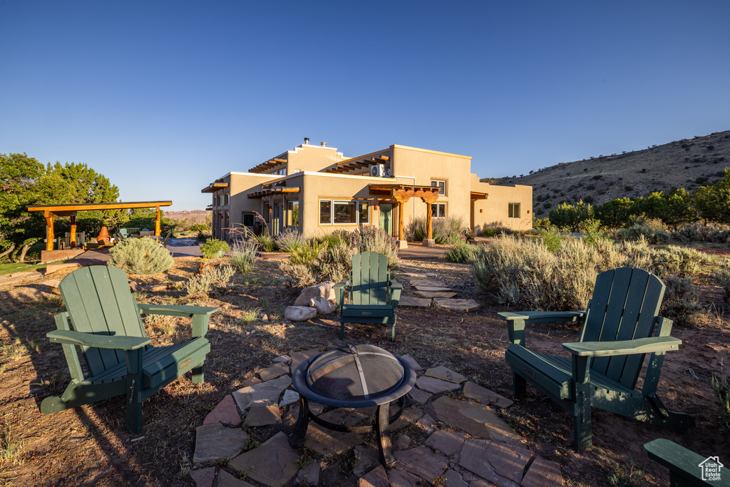 View of patio featuring a fire pit and a mountain view