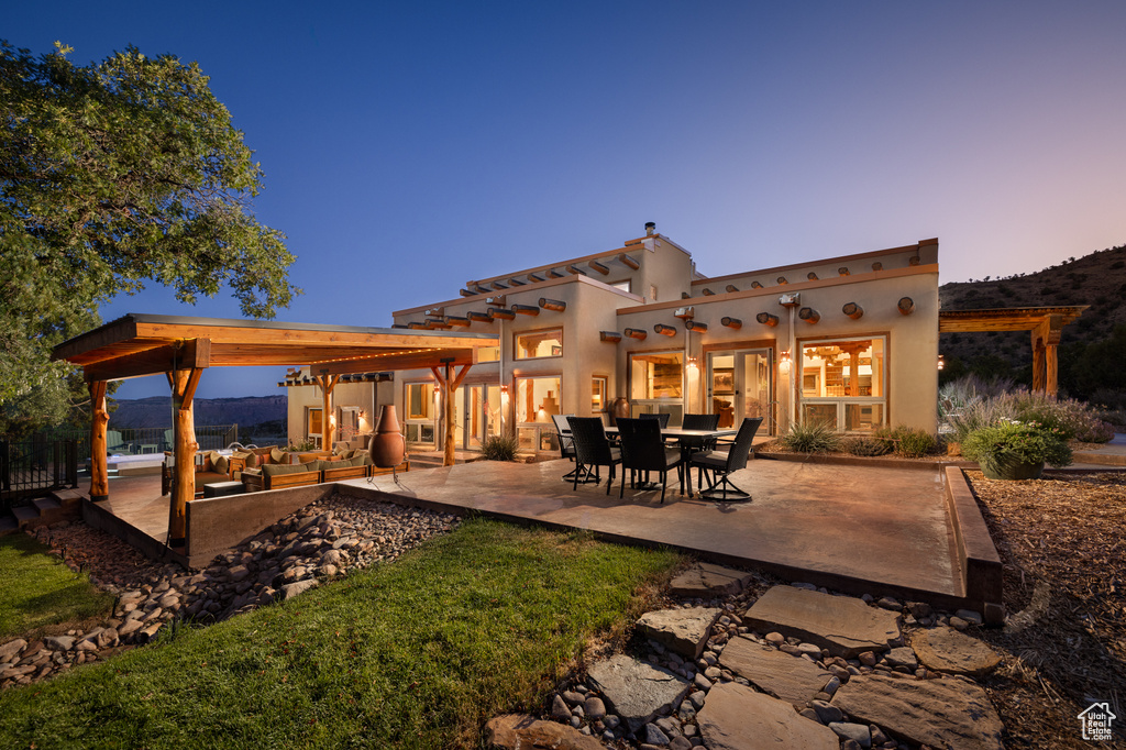 Back of property featuring a patio and stucco siding