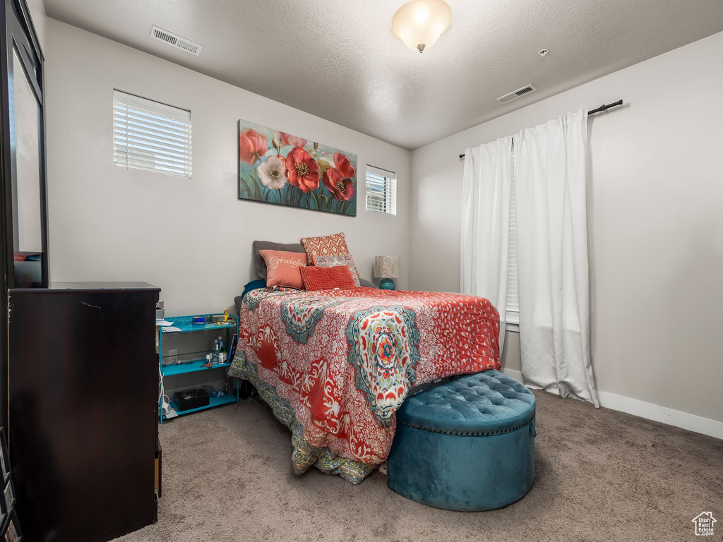 Carpeted bedroom featuring baseboards