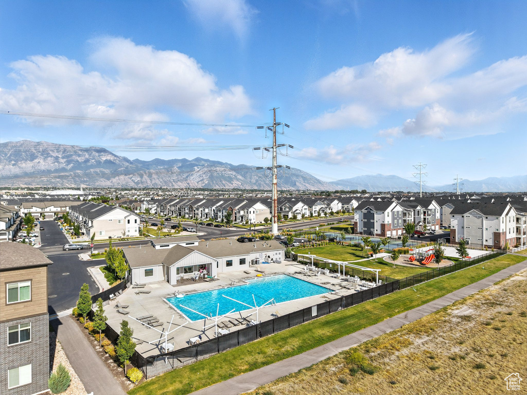 Community pool featuring a residential view, a mountain view, and a patio area