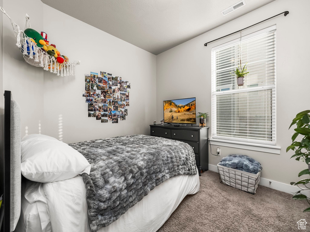 Bedroom featuring carpet floors and baseboards