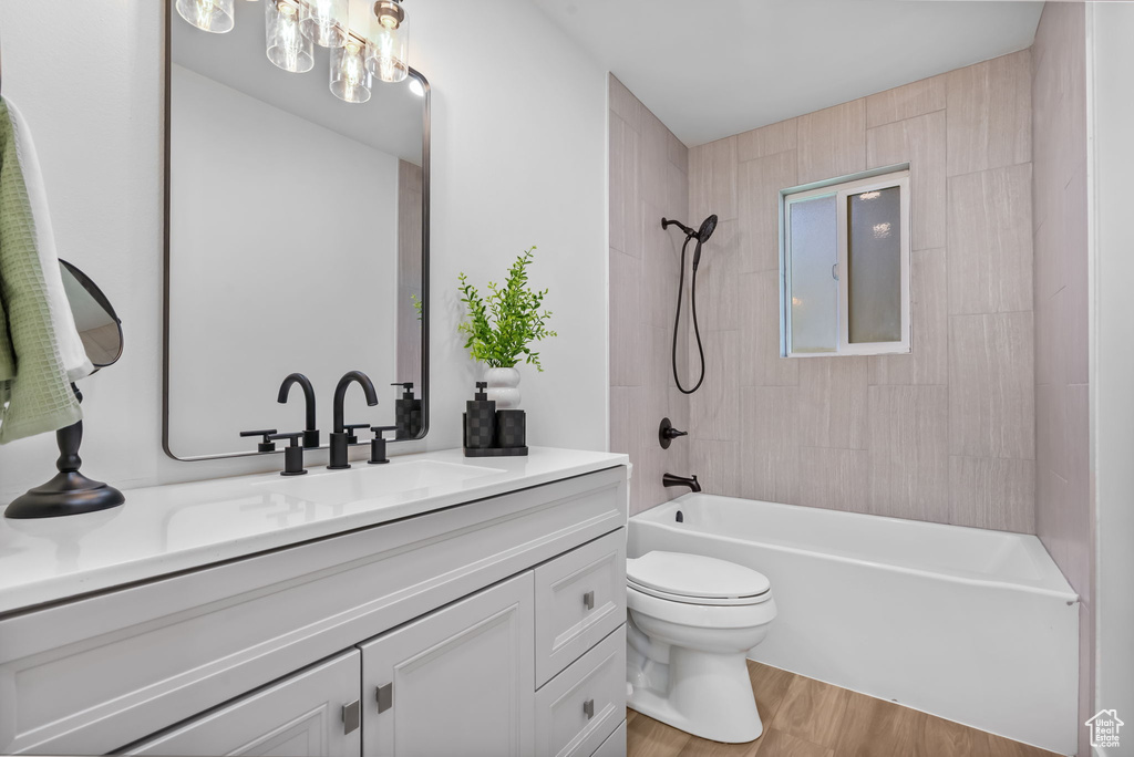 Bathroom featuring vanity, wood finished floors, and bathtub / shower combination