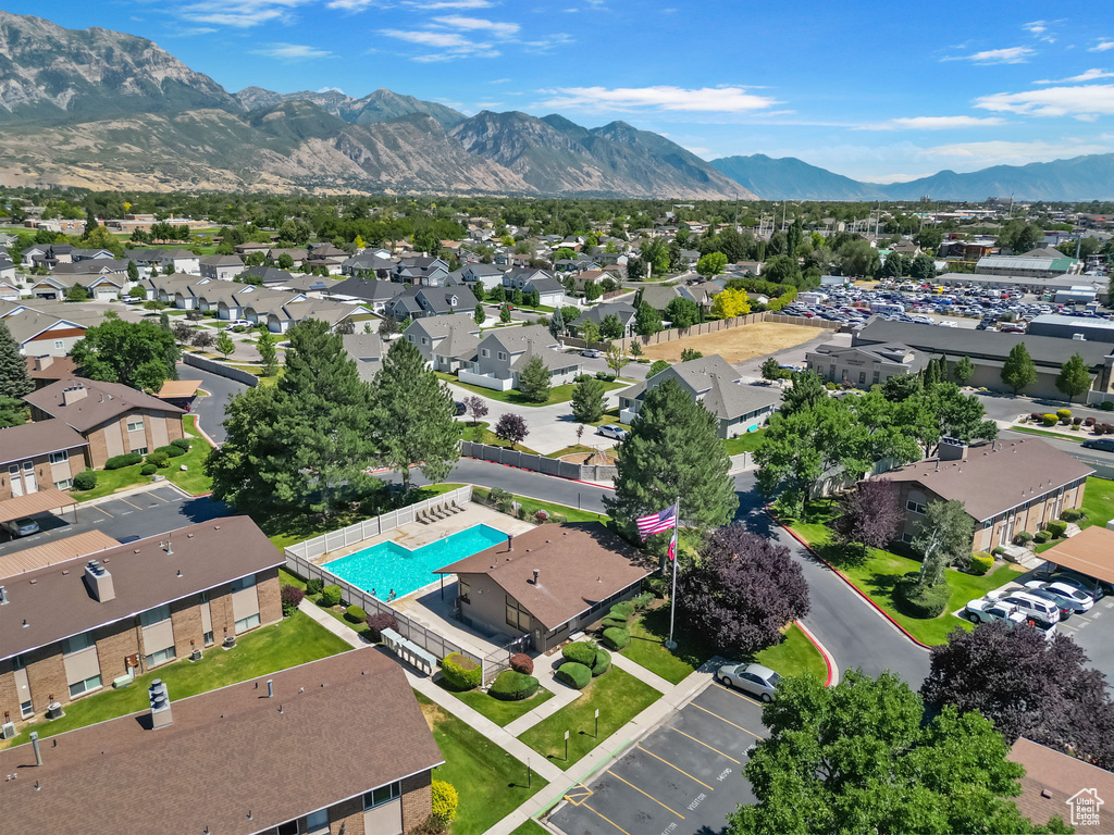 Aerial view of residential area with a pool and a mountain backdrop