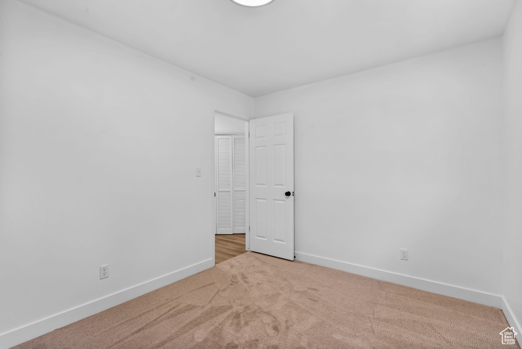 Unfurnished room featuring carpet floors and baseboards