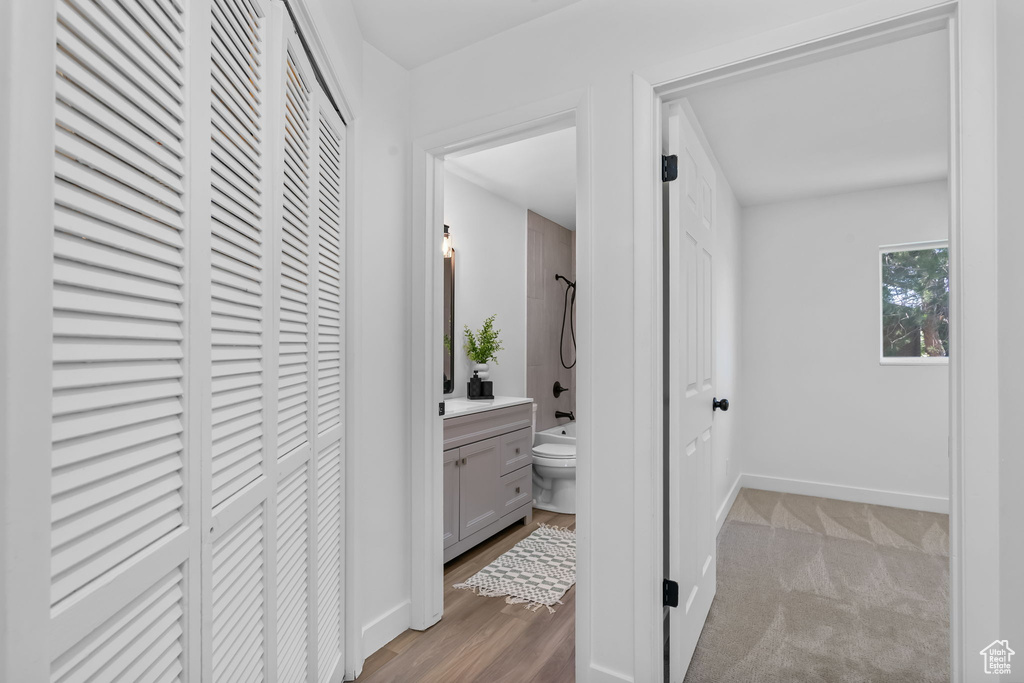 Hall featuring baseboards and wood finished floors