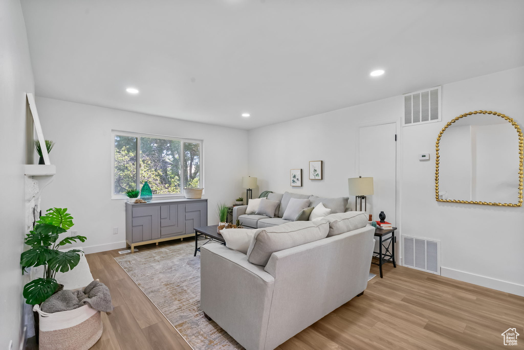 Living room with wood finished floors and recessed lighting