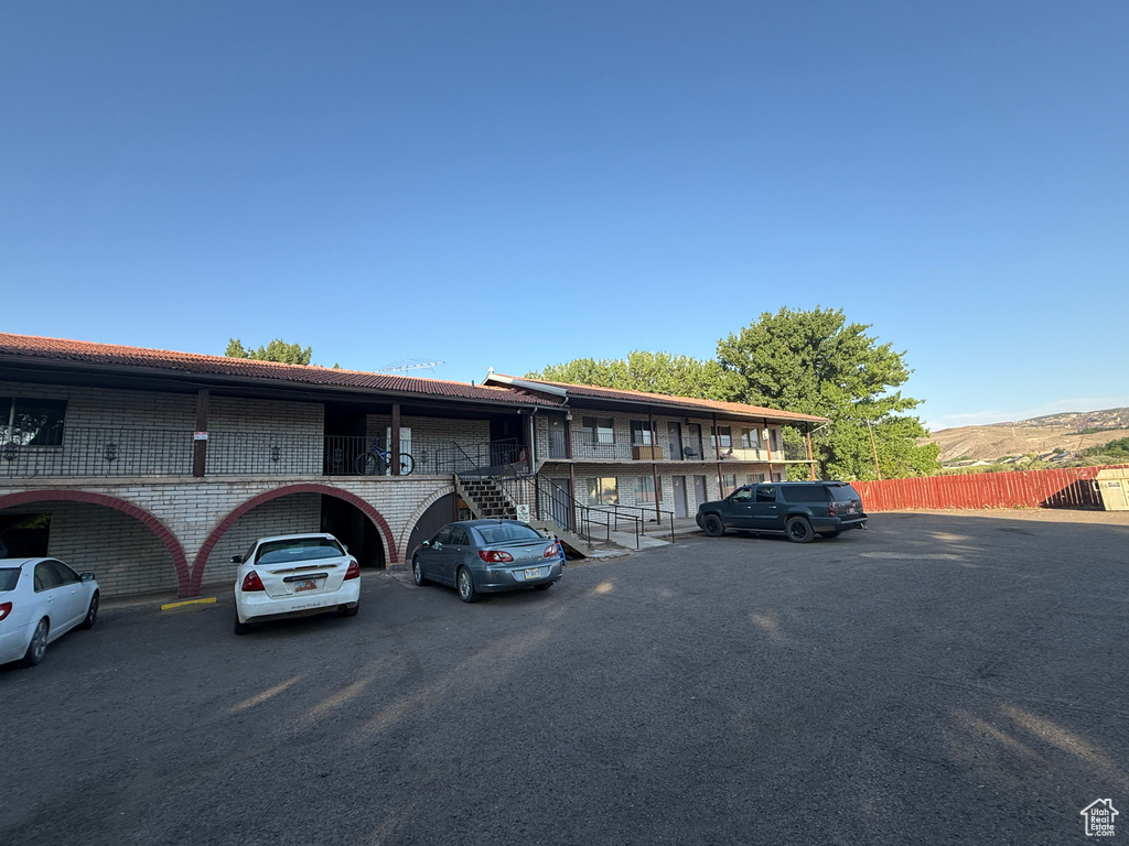 View of property featuring uncovered parking