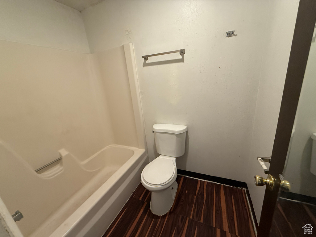Bathroom featuring wood finished floors and shower / washtub combination