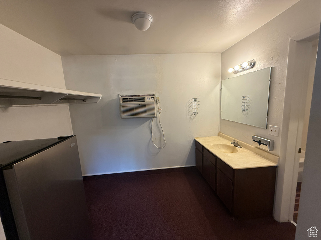 Bathroom featuring an AC wall unit and vanity