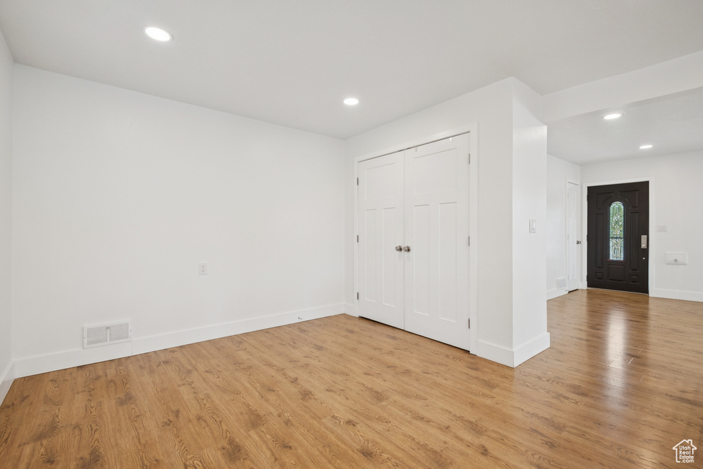 Unfurnished bedroom featuring light wood finished floors, recessed lighting, and a closet