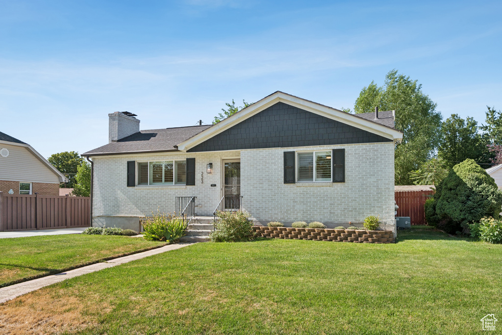 Single story home with brick siding and a chimney
