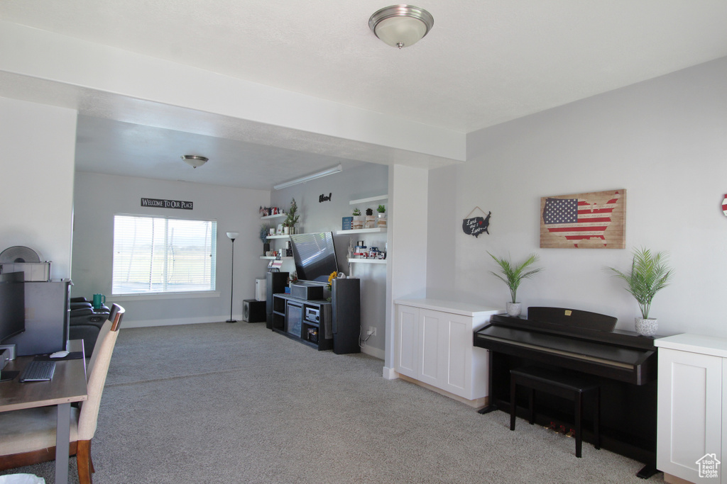 Living room with light colored carpet and baseboards