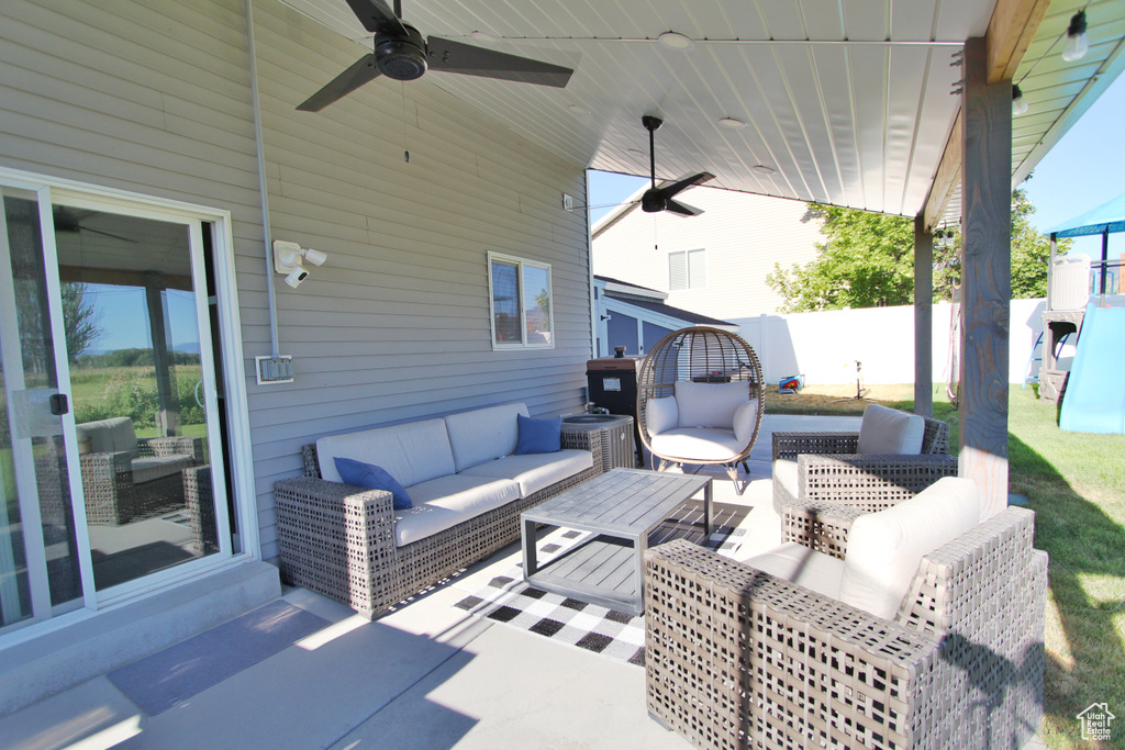 View of patio with an outdoor hangout area and a ceiling fan