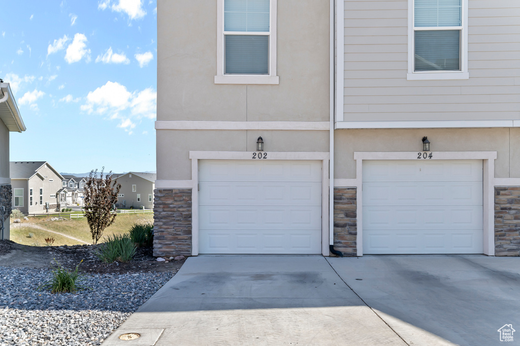 Garage featuring concrete driveway
