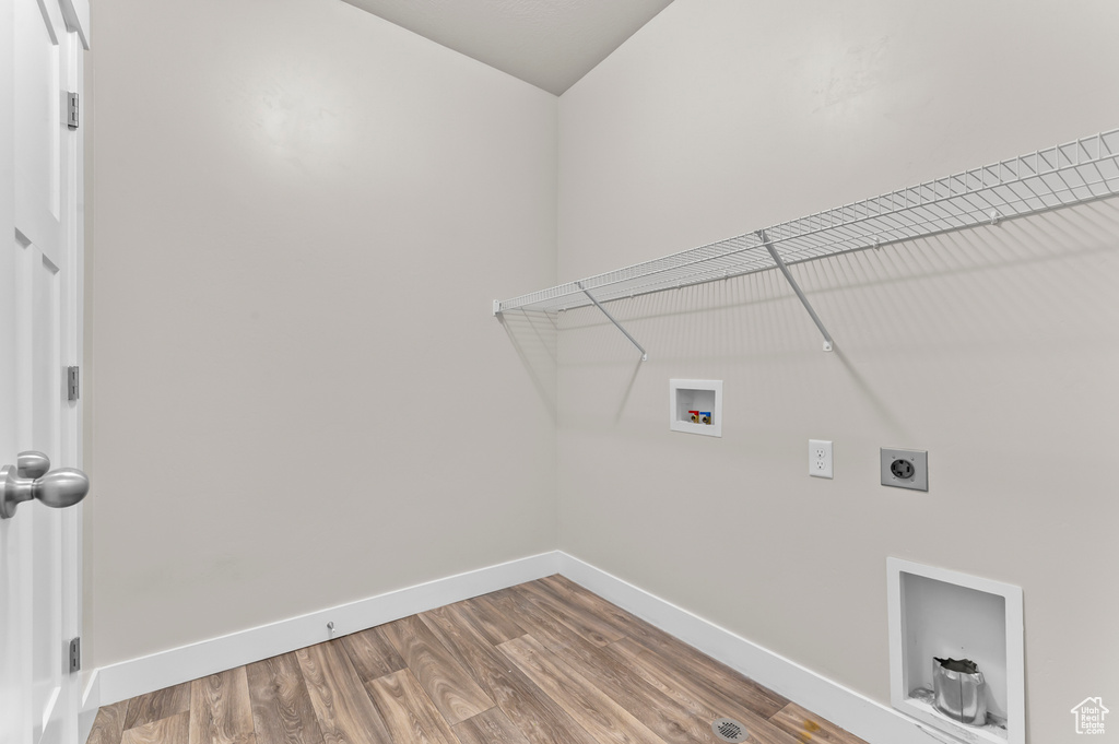 Laundry room with hookup for a washing machine, hookup for an electric dryer, and wood finished floors
