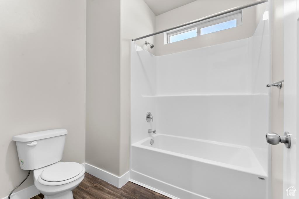 Bathroom featuring wood finished floors and bathtub / shower combination