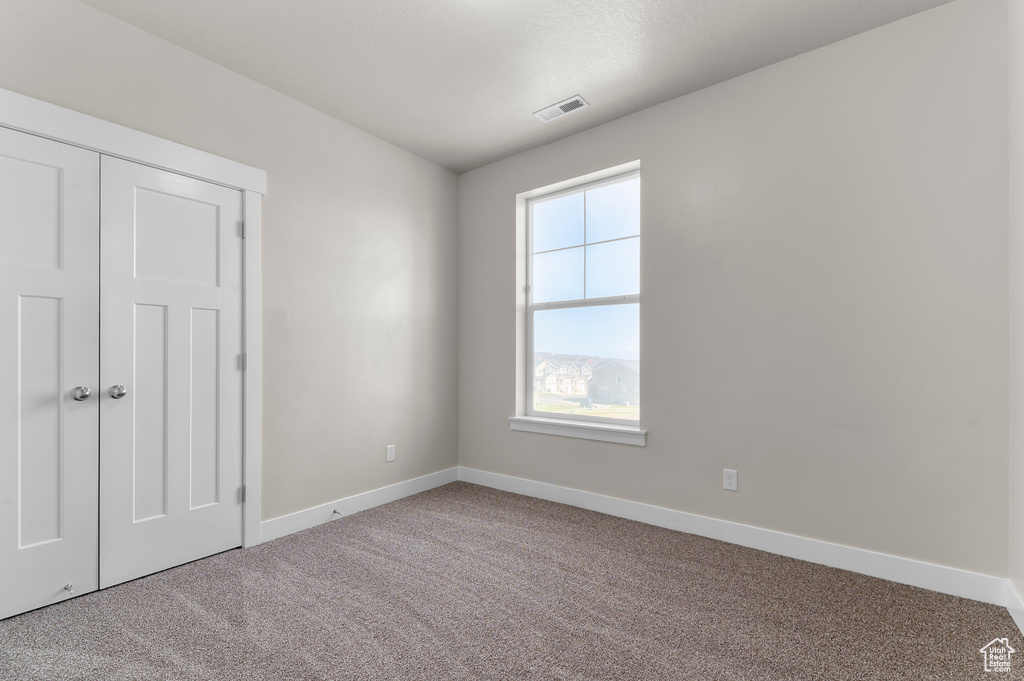 Unfurnished bedroom featuring carpet floors