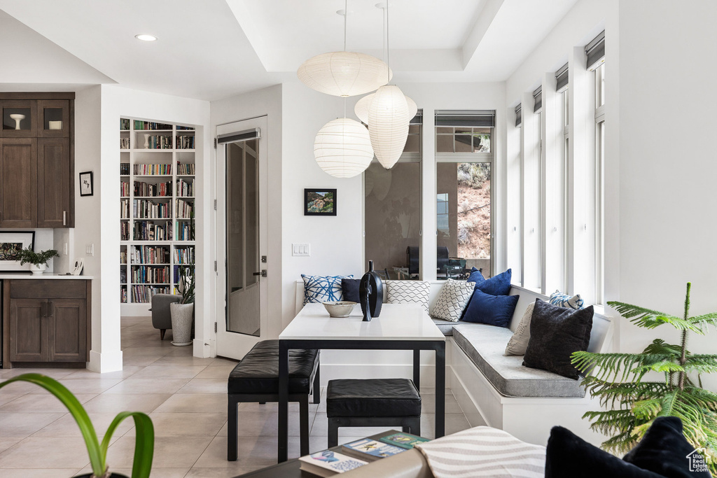 Living area with built in features and light tile patterned floors