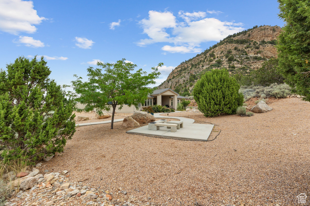 View of yard featuring a mountain view and a patio area