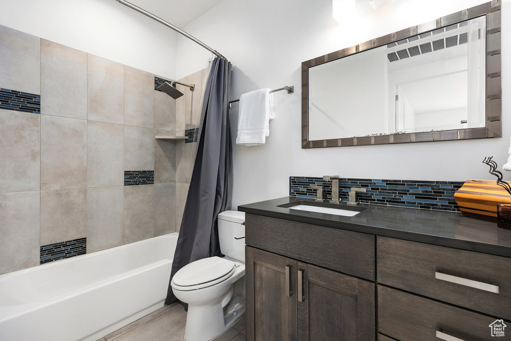 Full bath featuring vanity, shower / tub combo with curtain, and backsplash