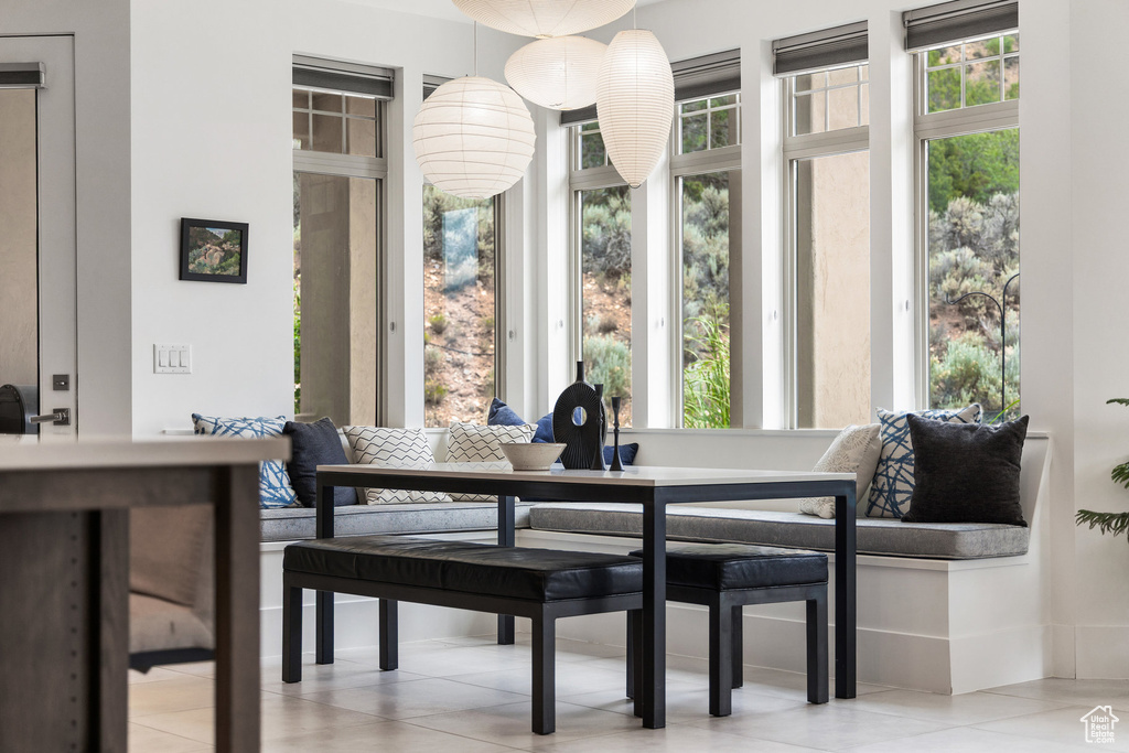 Dining room with plenty of natural light and tile patterned floors