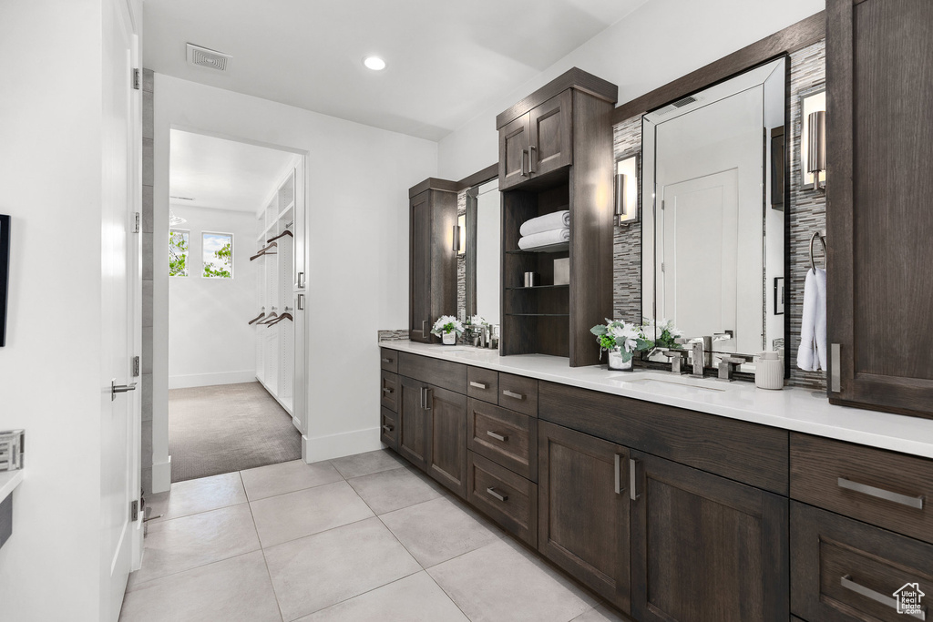 Full bathroom with double vanity, tile patterned flooring, and recessed lighting