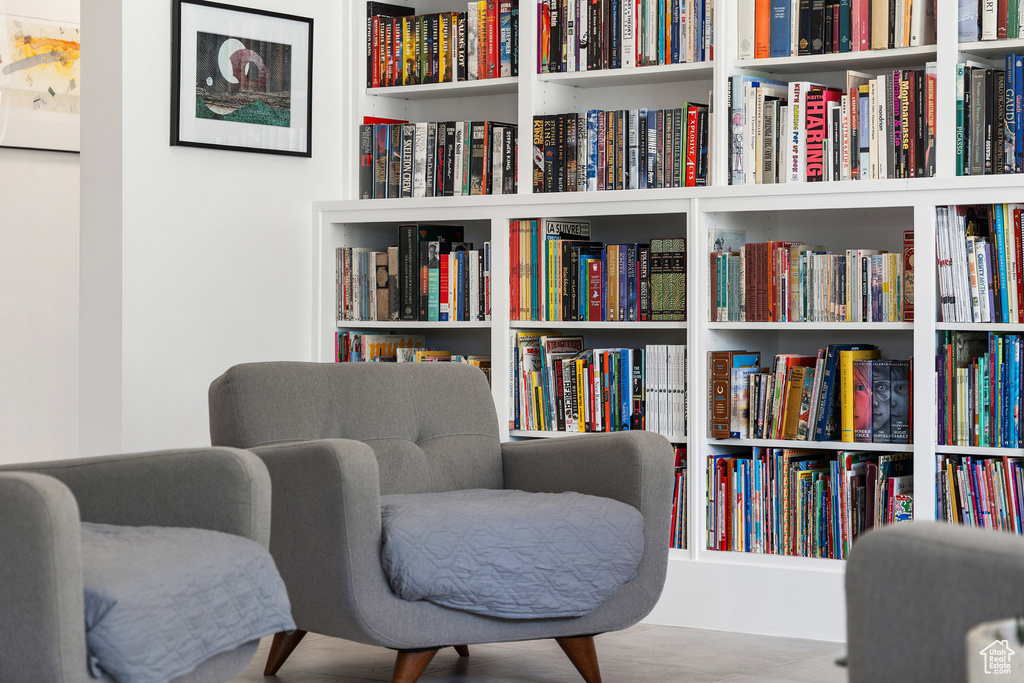 Sitting room featuring wall of books