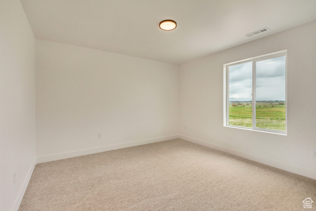 Empty room with carpet flooring and baseboards