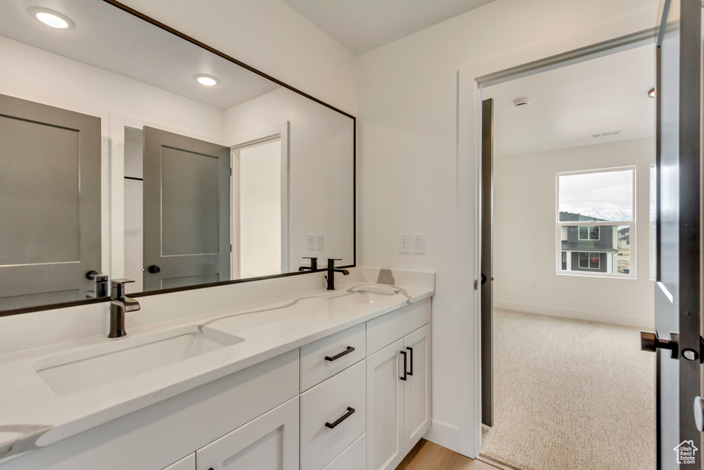 Bathroom featuring double vanity and recessed lighting