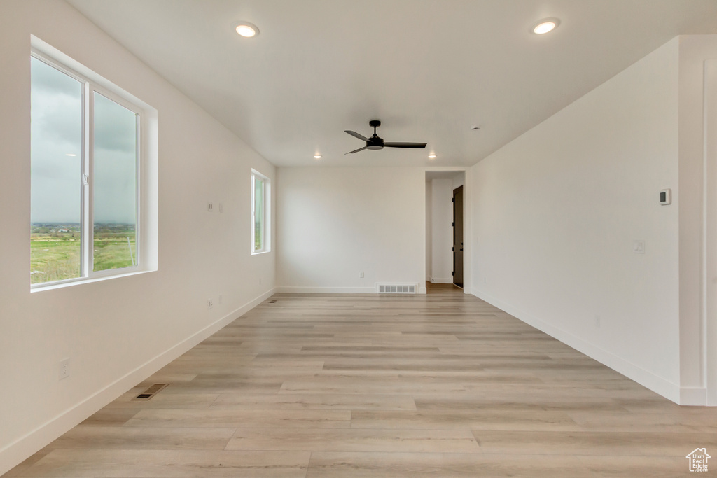 Empty room featuring a ceiling fan, recessed lighting, and light wood finished floors