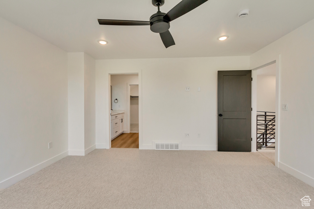 Unfurnished bedroom featuring light carpet, recessed lighting, and ceiling fan
