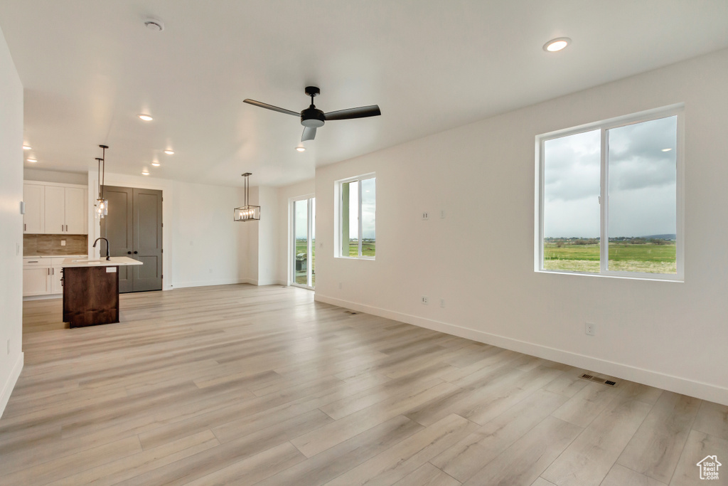 Unfurnished living room featuring recessed lighting, light wood-type flooring, and ceiling fan