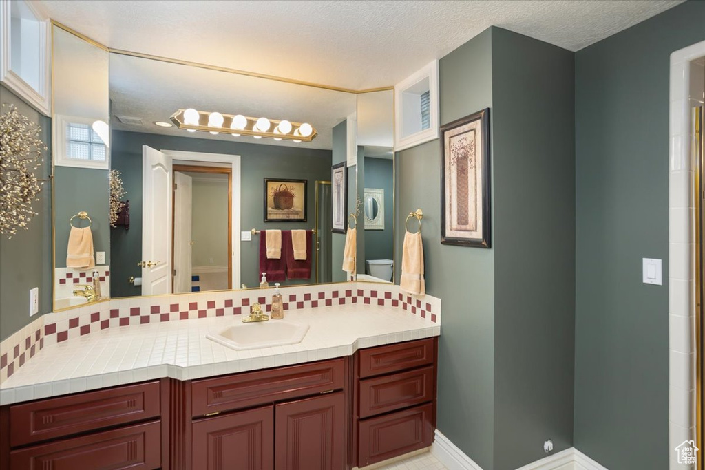 Full bathroom with vanity and curtained shower