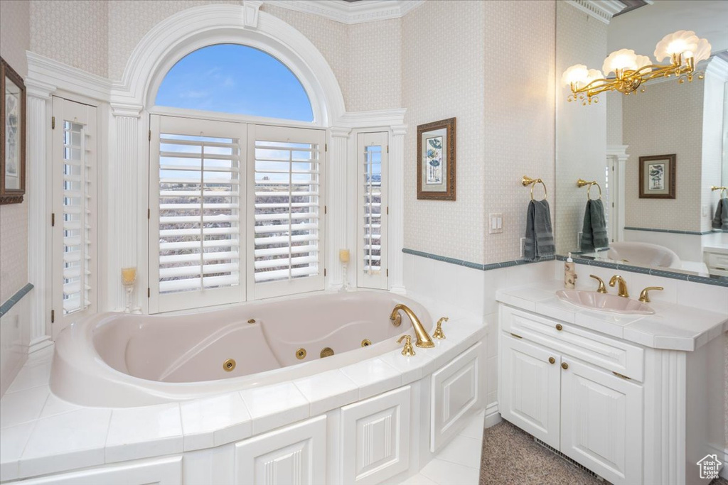 Full bathroom with a chandelier, a whirlpool tub, vanity, and wallpapered walls