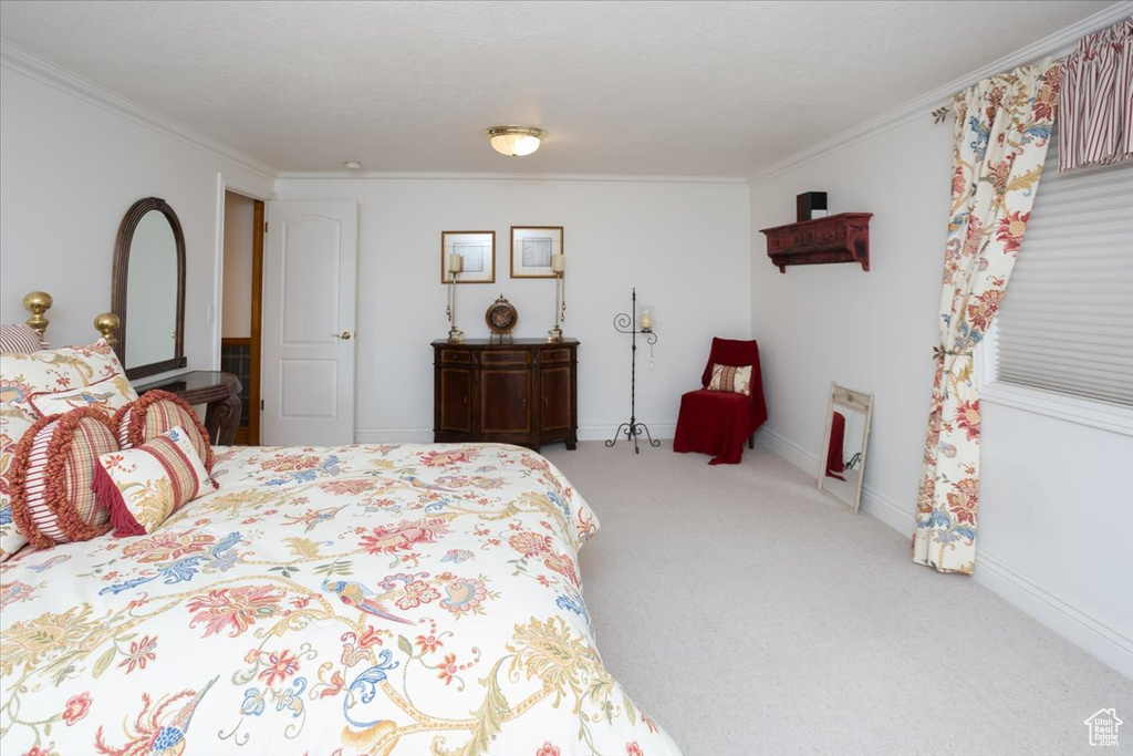 Carpeted bedroom featuring ornamental molding