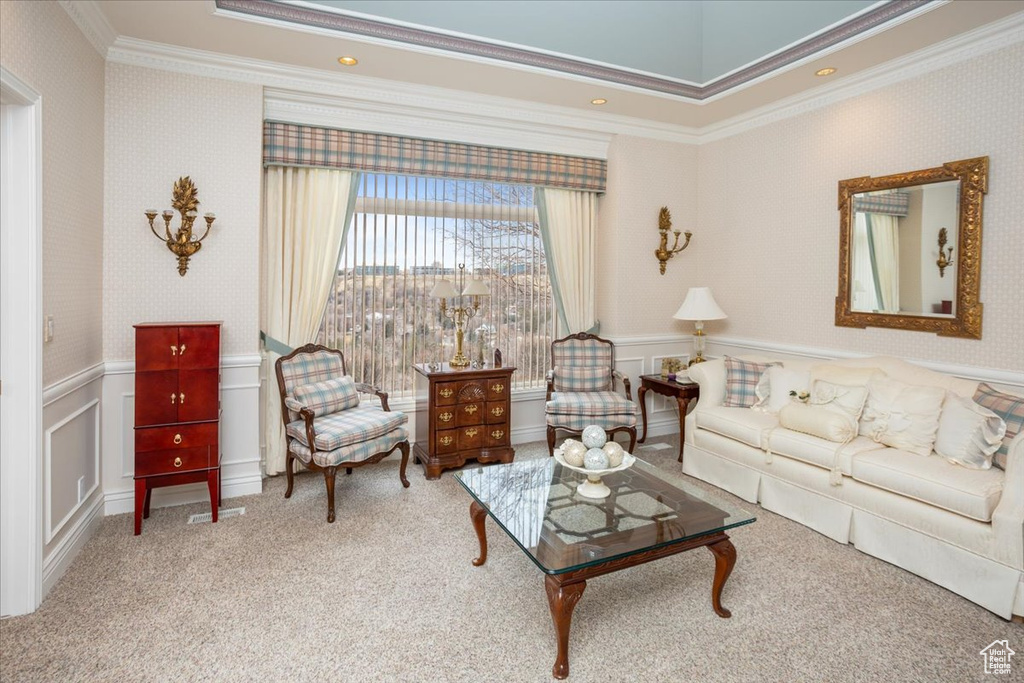 Living area with crown molding, carpet flooring, a wainscoted wall, wallpapered walls, and a decorative wall