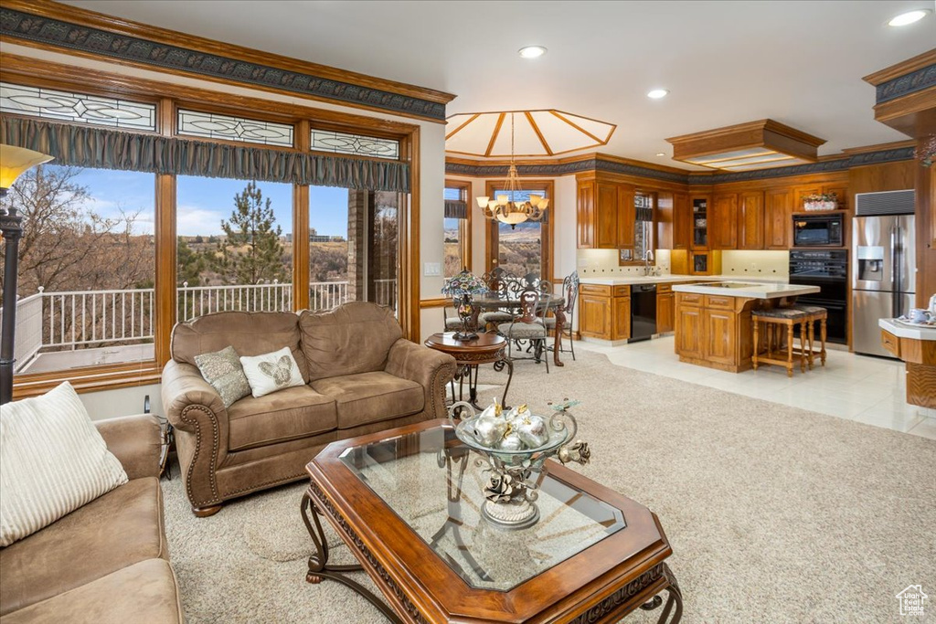 Living room with ornamental molding, a chandelier, recessed lighting, and light tile patterned flooring