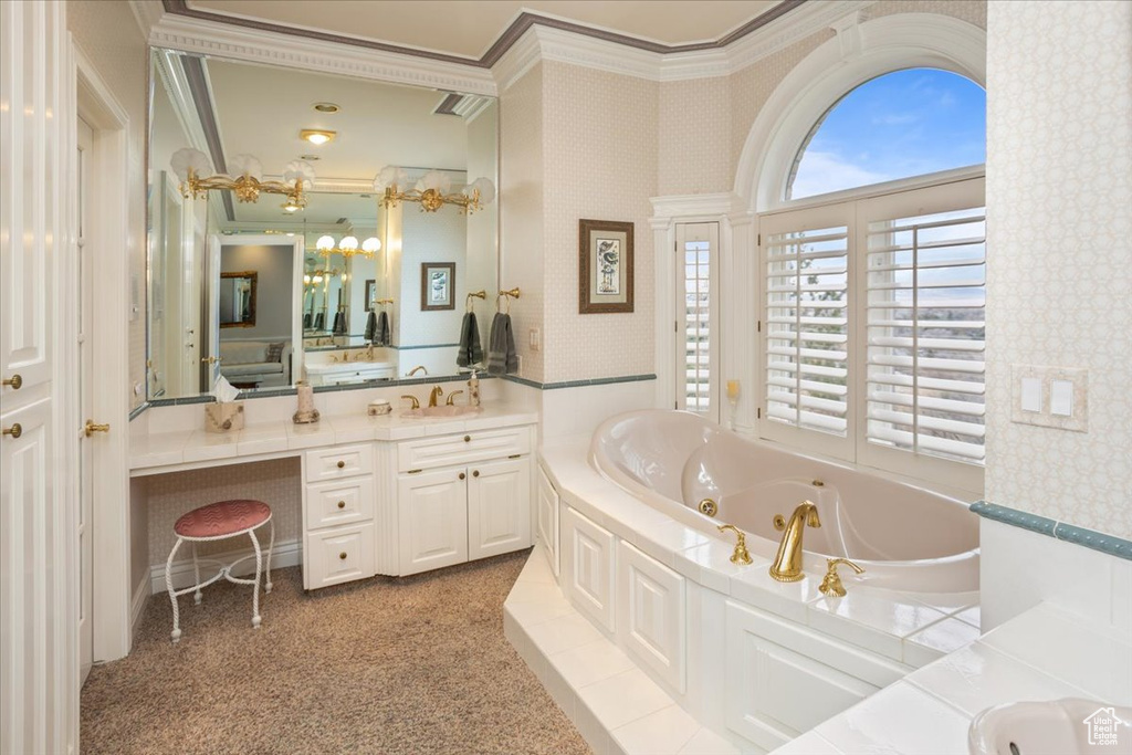 Bathroom with wallpapered walls, vanity, crown molding, a whirlpool tub, and a chandelier