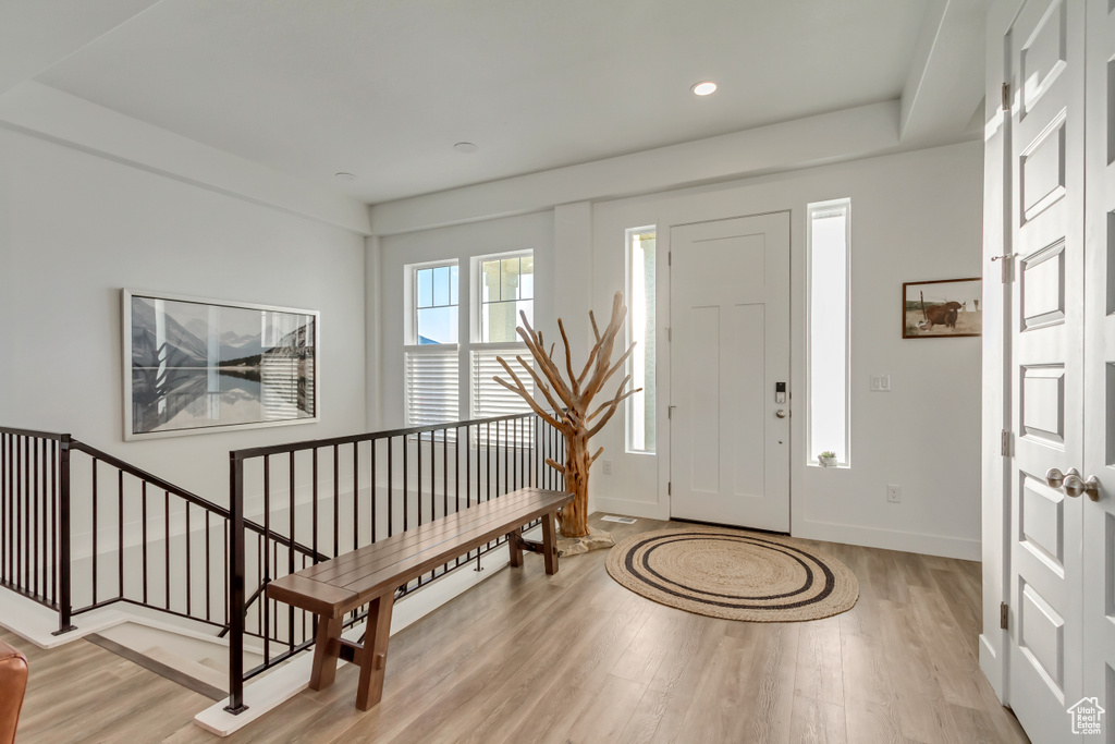 Foyer entrance with light wood-style flooring and recessed lighting