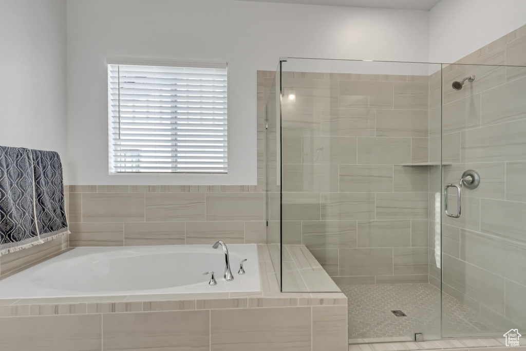 Full bath with a garden tub and a stall shower