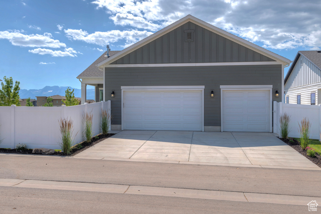 View of front of home with a garage, board and batten siding, and a mountain view