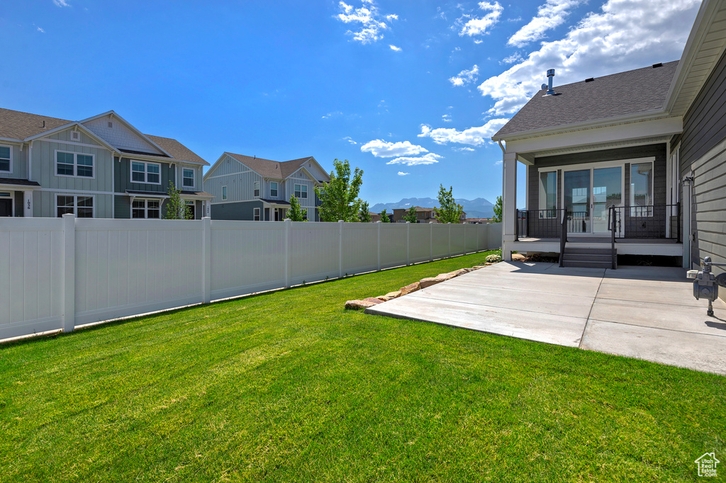 View of yard with a patio area, a residential view, and a mountain view