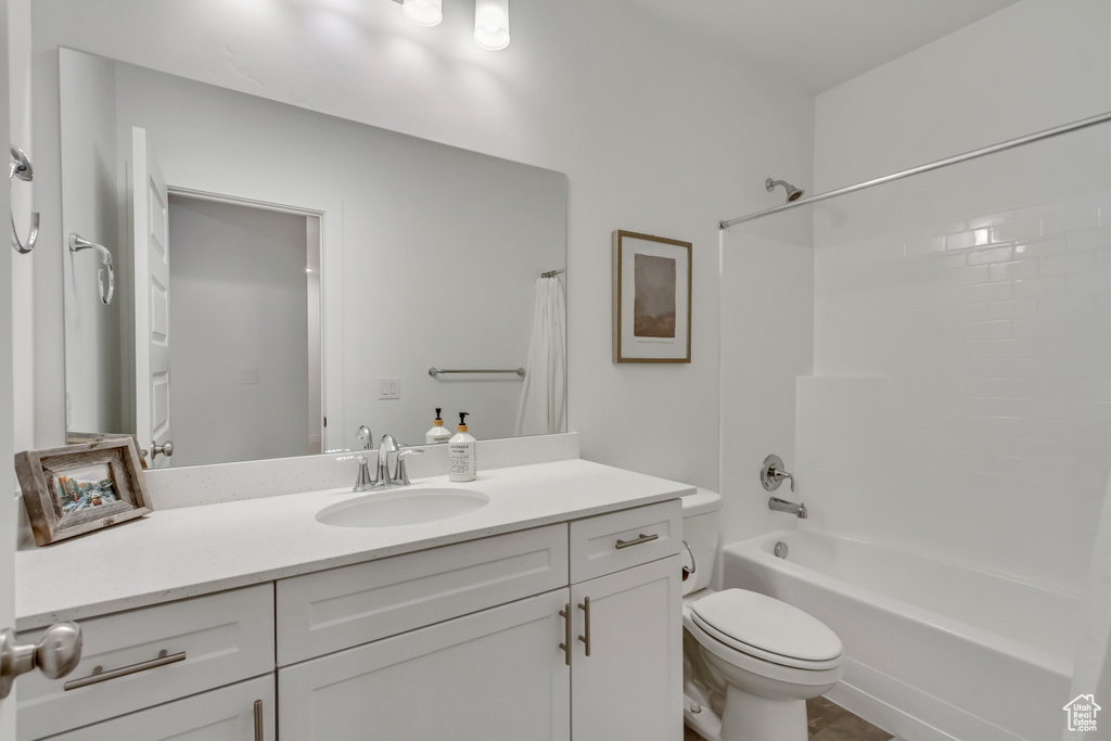 Full bathroom with shower / tub combo with curtain and vanity